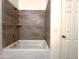 Bathtub with tiled surround and open shower, a serene bathroom retreat at 4440 S Leisure Way, Gilbert, AZ 85297
