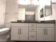 Bathroom featuring double sinks, white cabinets, and a modern vanity at 4440 S Leisure Way, Gilbert, AZ 85297