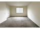 Cozy bedroom with a window offering natural light and a spacious closet at 4440 S Leisure Way, Gilbert, AZ 85297