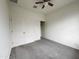Carpeted bedroom with fan, closet with sliding doors, and white-painted walls at 4440 S Leisure Way, Gilbert, AZ 85297