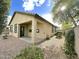 A side view of the home's exterior and covered patio, with well-kept landscaping and gravel groundcover at 4440 S Leisure Way, Gilbert, AZ 85297