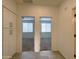 Bright hallway with tiled floors leading to carpeted bedrooms, offering ample storage space at 4440 S Leisure Way, Gilbert, AZ 85297