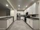 Bright, modern kitchen with white cabinetry, stainless steel appliances, and a spacious layout with tiled floors at 4440 S Leisure Way, Gilbert, AZ 85297