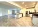 Open-concept layout showcasing the kitchen with stainless steel appliances, breakfast bar, and seamless flow to the living area at 4440 S Leisure Way, Gilbert, AZ 85297
