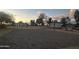 Community sand volleyball court with net, surrounded by walking path, and picnic areas at sunset at 4440 S Leisure Way, Gilbert, AZ 85297