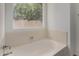 Bathroom featuring soaking tub with garden window at 4544 E Campo Bello Dr, Phoenix, AZ 85032