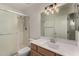 Bathroom featuring shower with glass door, toilet, sink, mirror, and lighting at 4544 E Campo Bello Dr, Phoenix, AZ 85032