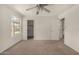 Spacious bedroom with ceiling fan, neutral carpet, window, and multiple doorways at 4544 E Campo Bello Dr, Phoenix, AZ 85032