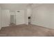Spacious bedroom with neutral carpet, ceiling fan, and multiple doorways at 4544 E Campo Bello Dr, Phoenix, AZ 85032