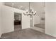 Carpeted dining room featuring a modern chandelier and open access to other rooms at 4544 E Campo Bello Dr, Phoenix, AZ 85032