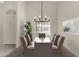Elegant dining room featuring stylish furnishings, a modern chandelier, and ample natural light at 4544 E Campo Bello Dr, Phoenix, AZ 85032