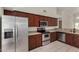 Functional kitchen with stainless steel appliances, dark wood cabinets, and ample counter space at 4544 E Campo Bello Dr, Phoenix, AZ 85032