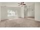 Spacious living room with a ceiling fan, a large window, and a connecting dining room at 4544 E Campo Bello Dr, Phoenix, AZ 85032