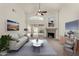 Bright living room featuring a fireplace, stylish furniture, and sliding doors to the backyard at 4544 E Campo Bello Dr, Phoenix, AZ 85032