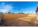 An expansive backyard featuring a wooden fence, clear blue skies, and lots of space at 4922 W Coolidge St, Phoenix, AZ 85031