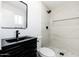 Modern bathroom featuring a black vanity, marble shower, and stylish fixtures at 4922 W Coolidge St, Phoenix, AZ 85031