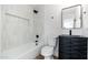 Modern bathroom featuring a stylish vanity, sleek mirror, and tiled shower with a black shower head at 4922 W Coolidge St, Phoenix, AZ 85031