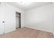 A carpeted bedroom features a closet and white walls for a cozy and minimalist space at 4922 W Coolidge St, Phoenix, AZ 85031
