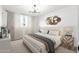 Stylishly decorated bedroom featuring a large window, modern lighting, and neutral colors at 4922 W Coolidge St, Phoenix, AZ 85031