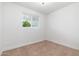 Cozy bedroom showcasing a bright window and neutral carpet complemented by white brick walls at 4922 W Coolidge St, Phoenix, AZ 85031