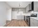 Modern kitchen with gray cabinetry, stainless steel appliances, and stylish hardware at 4922 W Coolidge St, Phoenix, AZ 85031