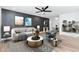 Stylish living room featuring a modern sofa, accent chair, and contemporary decor with a dark accent wall at 4922 W Coolidge St, Phoenix, AZ 85031