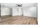 A bright, open-concept living room with wood-look floors and a modern ceiling fan at 4922 W Coolidge St, Phoenix, AZ 85031