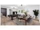 Living and dining area featuring a pool table, dining table, and large windows at 4922 W Coolidge St, Phoenix, AZ 85031