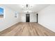 Spacious living room featuring contemporary lighting, wood floors, and ample natural light at 4922 W Coolidge St, Phoenix, AZ 85031