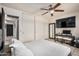 Bedroom with a king bed, ceiling fan, closet and a TV on a desk at 5159 W Vernon Ave, Phoenix, AZ 85035