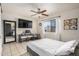 Comfortable bedroom featuring a large window, ceiling fan, and a mounted TV at 5159 W Vernon Ave, Phoenix, AZ 85035