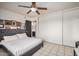 Cozy bedroom showcasing a queen bed with a gray headboard and closet, providing comfortable living space at 5159 W Vernon Ave, Phoenix, AZ 85035