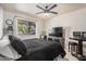 Bedroom with a ceiling fan, side table, and a window with bright, natural light at 5159 W Vernon Ave, Phoenix, AZ 85035