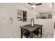 The dining area features a black table set, a window, and is lit by a ceiling fan at 5159 W Vernon Ave, Phoenix, AZ 85035