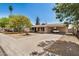 Exterior view of single-story house featuring covered parking and a long driveway at 5159 W Vernon Ave, Phoenix, AZ 85035