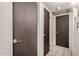 Hallway view of three doors in a home at 5159 W Vernon Ave, Phoenix, AZ 85035