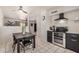 Bright kitchen with stainless steel appliances, dark cabinets, and an adjacent dining area at 5159 W Vernon Ave, Phoenix, AZ 85035