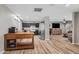 Open floor plan with a view from the kitchen to the living area, stainless steel appliances, and wooden island at 5325 E Thunderbird Rd, Scottsdale, AZ 85254