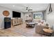 Cozy living room with a large sectional sofa, modern ceiling fan, and decorative rug on wood-look floors at 5325 E Thunderbird Rd, Scottsdale, AZ 85254