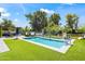 Backyard pool area features artificial turf, inground pool, basketball hoop, and relaxing outdoor seating at 5325 E Thunderbird Rd, Scottsdale, AZ 85254