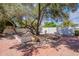 Beautiful backyard featuring a large shade tree and a well-maintained hardscape at 5539 E Dahlia Dr, Scottsdale, AZ 85254