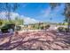 Wide backyard view, featuring a gorgeous lawn, refreshing pool, and covered patio at 5539 E Dahlia Dr, Scottsdale, AZ 85254