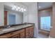 Bathroom showcasing double sinks, granite countertops, wood cabinetry, and a tiled shower area at 5539 E Dahlia Dr, Scottsdale, AZ 85254