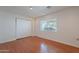 Bright bedroom featuring hardwood floors, a window and a built-in closet at 5539 E Dahlia Dr, Scottsdale, AZ 85254