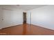 Neutral bedroom featuring hardwood floors and built-in closet at 5539 E Dahlia Dr, Scottsdale, AZ 85254