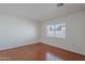 Well-lit bedroom featuring hardwood floors and a window at 5539 E Dahlia Dr, Scottsdale, AZ 85254