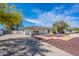 Expansive property with a long driveway leading to a well-maintained home and a secure fenced area at 5539 E Dahlia Dr, Scottsdale, AZ 85254