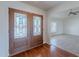 Elegant foyer with ornate glass double doors and hardwood floors, leading into a bright, open living space at 5539 E Dahlia Dr, Scottsdale, AZ 85254