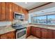 A spacious kitchen features stainless steel appliances, granite countertops, and wooden cabinets at 5539 E Dahlia Dr, Scottsdale, AZ 85254