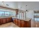 Stylish kitchen island with granite countertops, custom wooden cabinets, and modern lighting fixtures at 5539 E Dahlia Dr, Scottsdale, AZ 85254